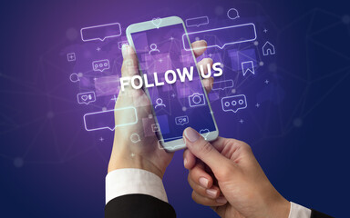 Obraz premium Female hand typing on smartphone with FOLLOW US inscription, social media concept