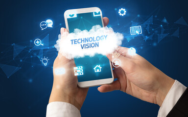 Female hand holding smartphone with TECHNOLOGY VISION inscription, cloud technology concept