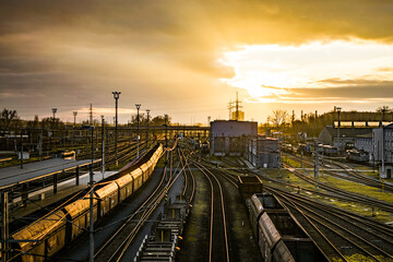 Fototapeta na wymiar bright cloudy sunset over old train station Ostrava railroad
