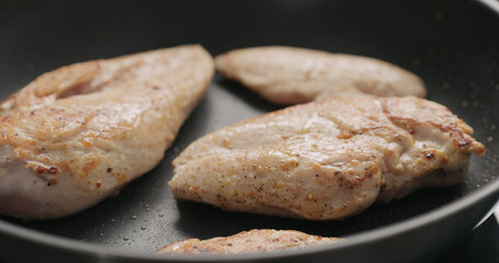 chicken fillet frying on non-stick pan
