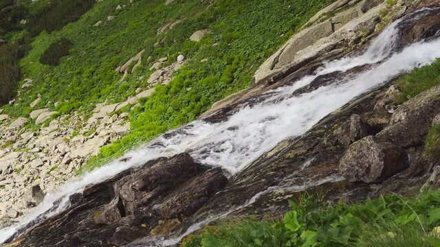 Close-up scenic view of Velicky vodopad (Velicky waterfall) in Slovakia, High Tatras mountains. Wild flowing water on steep rocky mountains, beautiful summer day