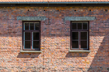 dark windows in old brick wall abandoned building