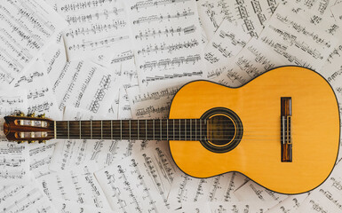 classical acoustic guitar on a sheet music background