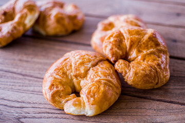 Freshly croissant on wooden background. It is a type of French pastry suitable as breakfast. It can be purchased at bakery worldwide.