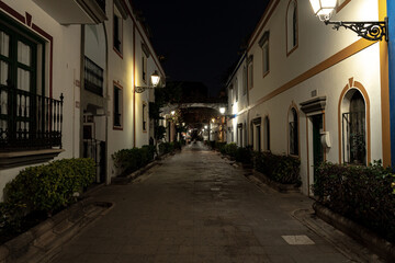 Fototapeta na wymiar streets of la benezia de canarias in mogan gran canaria at night with beautiful night lights flowers and beautiful architecture of houses