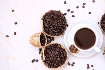 coffee beans andcup of coffee on wooden table cup