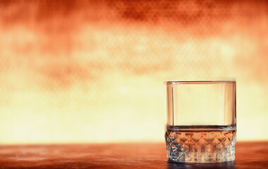 A glass of hard alcohol with ice on a bar counter. Whiskey with soda in a glass. Advertising alcoholic drink.