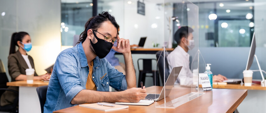 Social distance office with business team wear face mask as new normal life