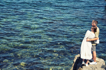 Young attractive couple is resting at the sea. 