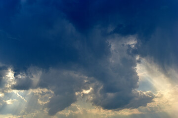 Fototapeta na wymiar Evening sky with Cumulus clouds and sunset sun