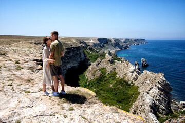 Young attractive couple is resting at the sea. 
