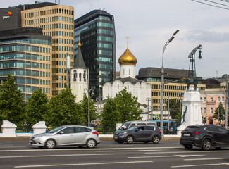 Fototapeta na wymiar Church of St. Nicholas at Tverskaya Zastava and modern business center on a cloudy summer day and space for copying in Moscow Russia