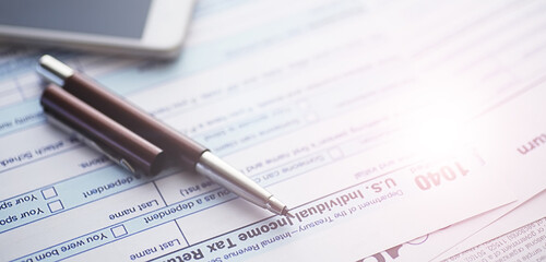 Annual tax reporting. Tax form on the table. Financial statements for signature.