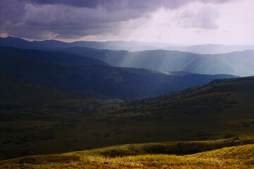 Fototapeta premium Panoramic sunset view high in the mountains in summer. Real grain scanned film.