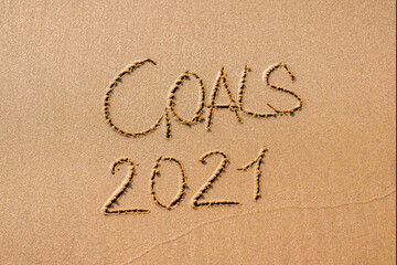 foamy sea water and Inscription Goals 2021 on the sandy beach