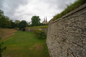 View of the city French Bayonne from the side of the fortress wall in summer cloudy day. The domes of high famous Saint Mary's cathedral in distance. High resolution image.