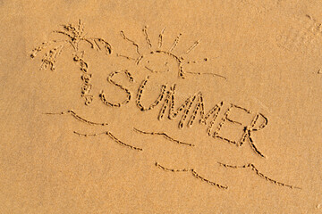 Sun, palm and the inscription summer on the sea sandy beach