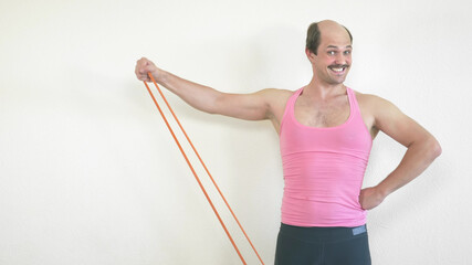 handsome cheerful balding man goes in for sports at home