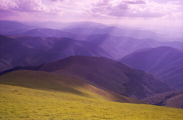 Panoramic sunset view high in the mountains in summer. Real grain scanned film.