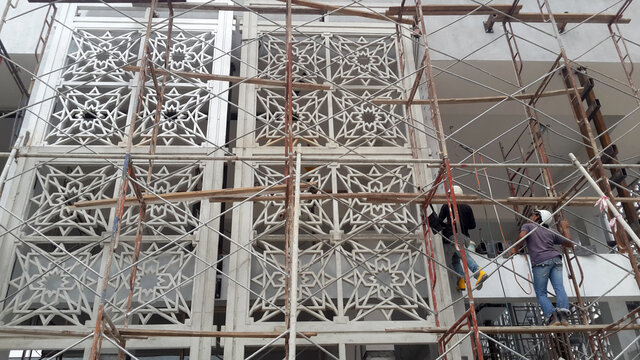 KUALA LUMPUR, MALAYSIA -AUGUST 16, 2018: GRC (Glass Fibre Reinforce Concrete) with Islamic geometry pattern installation work at the construction site by the construction workers. 
