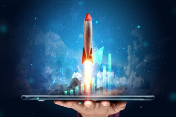 The inscription start-up, the rocket taking off on the background image of the development strategy charts, business concept, new technologies. Copy space.