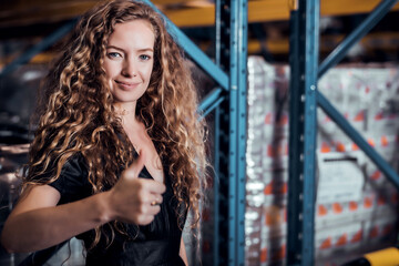 Obraz na płótnie Canvas Confident Caucasian woman owner standing and get thump up at goods warehouse store and check for control loading containers box from Cargo freight ship for import and export