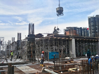 KUALA LUMPUR, MALAYSIA -AUGUST 23, 2019: Construction workers working at the construction site in Malaysia during the daytime. They are required to wearing appropriate safety gear to avoid an accident