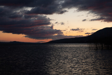 Beautiful Sunset on pebble beach at La pointe du grain, Neuchâtel, Switzerland
