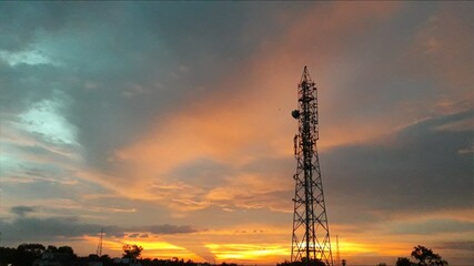 Cellular tower with colourful sky background 