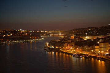 Fototapeta na wymiar View to Porto over river Douro with reflection of the lights at night