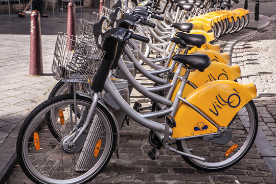 BRUSSELS, BELGIUM -  MAY 19, 2015: Yellow bicycles of self-service Villo for rent in historical center of Brussels