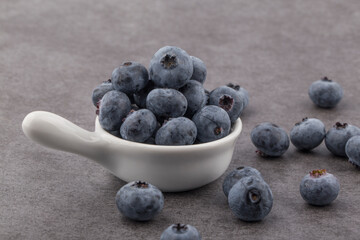 organic superfood blueberry berries on a gray background.