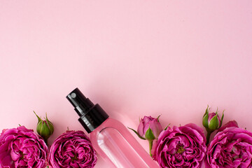 pink skin tonic in a plastic bottle with rose flowers
