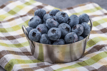 view of blueberries in bowls on fabric background.