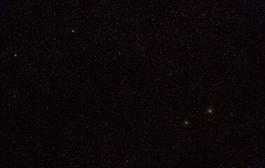 Many stars on night sky with bright Yed Prior and Posterior stars, Messier 10 and 12 deep space objects visible in upper left corner (long stacked exposure photo)