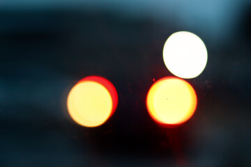 City traffic lights at night,  abstract blurry circles in rear view mirror