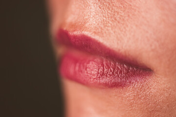 Red woman lips with natural skin without make up closeup. Selective focus.