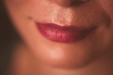Red woman lips with natural skin without make up closeup. Selective focus.