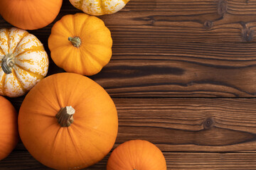 Border of pumpkins on wood background