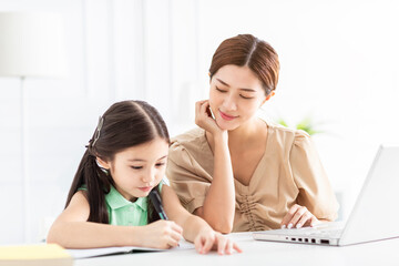 Mother is working and taking care of her daughter at home