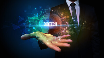 Elegant hand holding BIOTECH inscription, digital technology concept