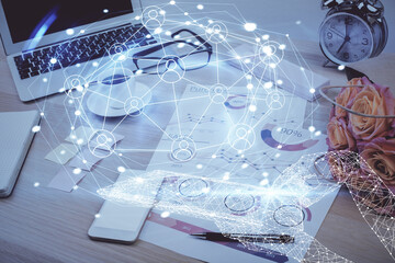 Computer on desktop with social network hologram. Double exposure. Concept of international people connections.