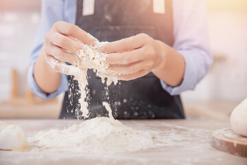 Woman hands making dough for pizza background white kitchen