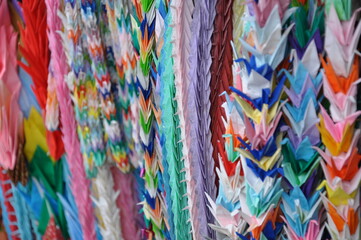 Many paper cranes of different colors