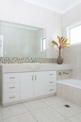 New white bathroom with granite bench top, splash back and tiled walls