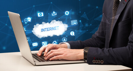 Businessman working on laptop with INTERNET inscription, modern technology concept