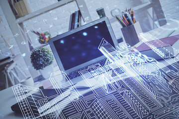 Desktop computer background in office and big town buildings hologram drawing. Double exposure. Smart city concept.