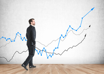 Young business man and growing graph