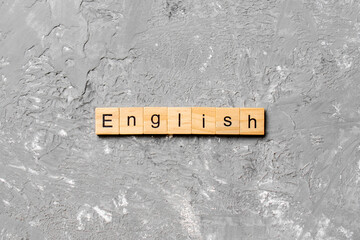 english word written on wood block. english text on cement table for your desing, concept