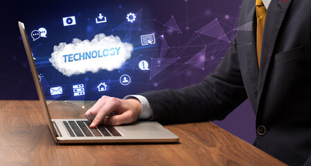 Businessman working on laptop with TECHNOLOGY inscription, modern technology concept